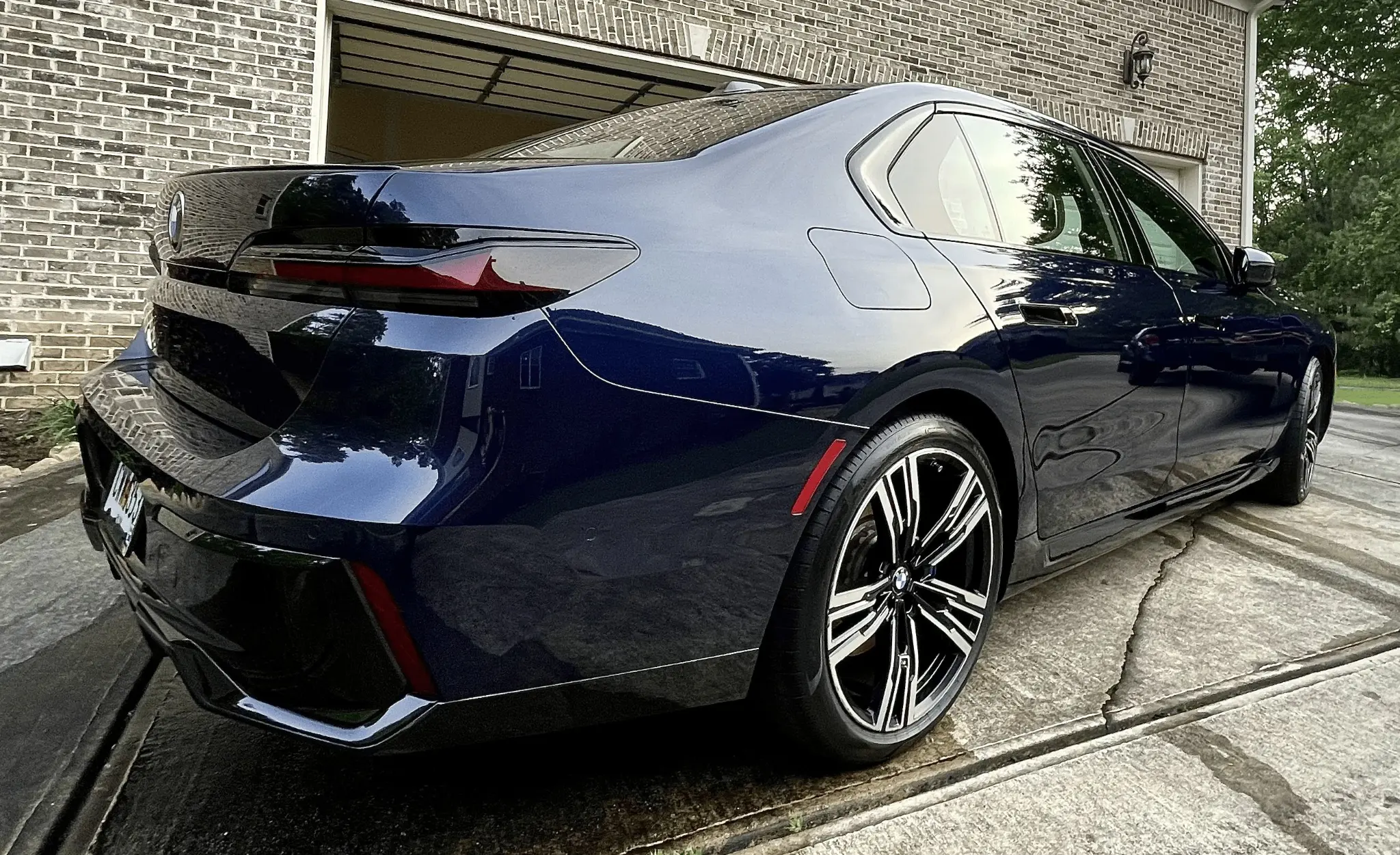 Sumptuous Mobile Detailing — navy blue BMW 7-series rear three-quarter view after full exterior detail at a client home